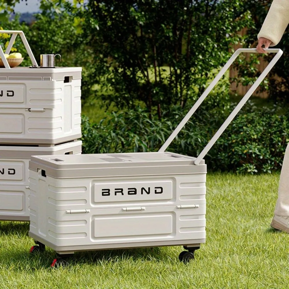 Boîte rangement pliable avec roues et poignet de tractage